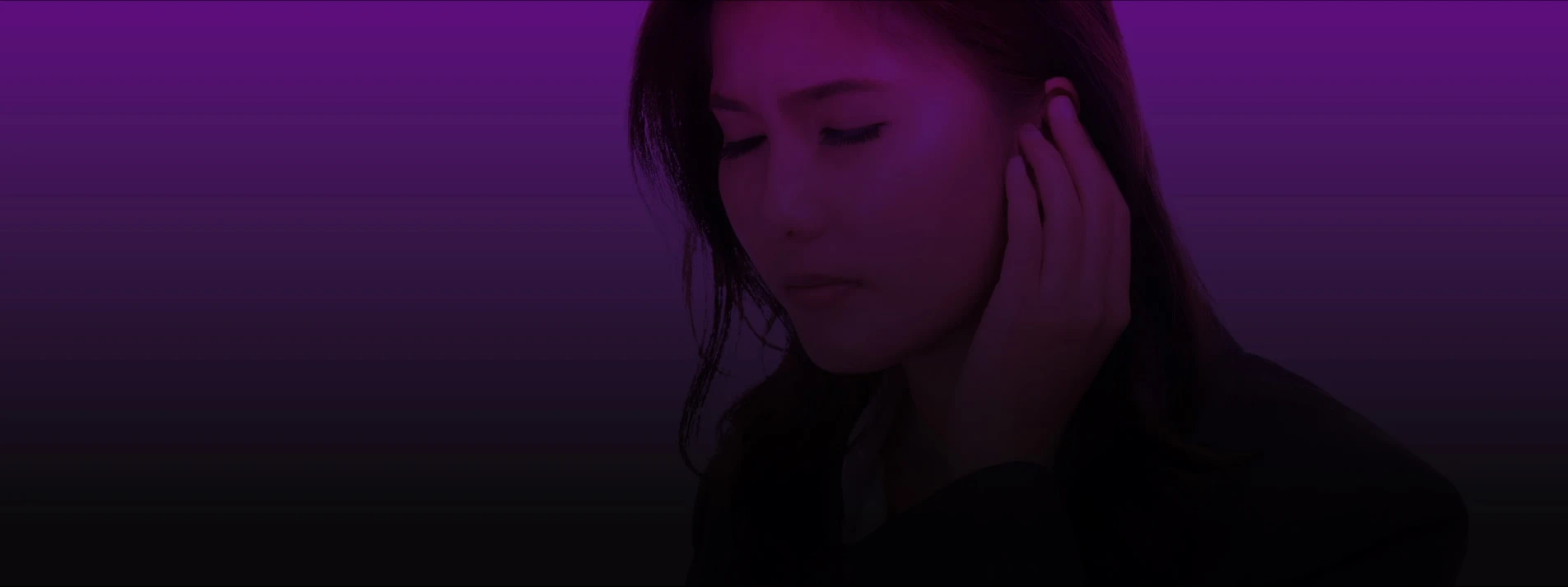 Woman holding ear in discomfort