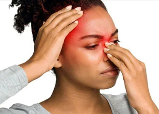 Woman holding nose and head in discomfort