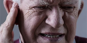 Man holding ear in pain