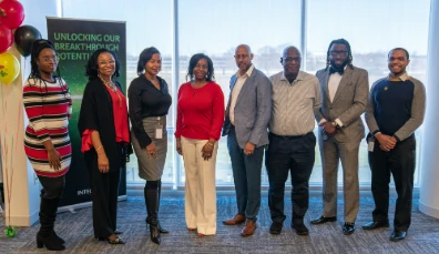 Black business people standing in front of a window