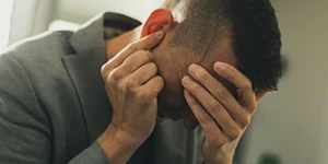 Man holding head in pain