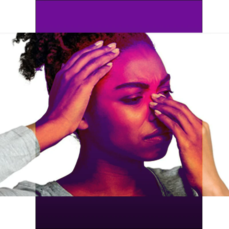 woman holding nose and head in discomfort